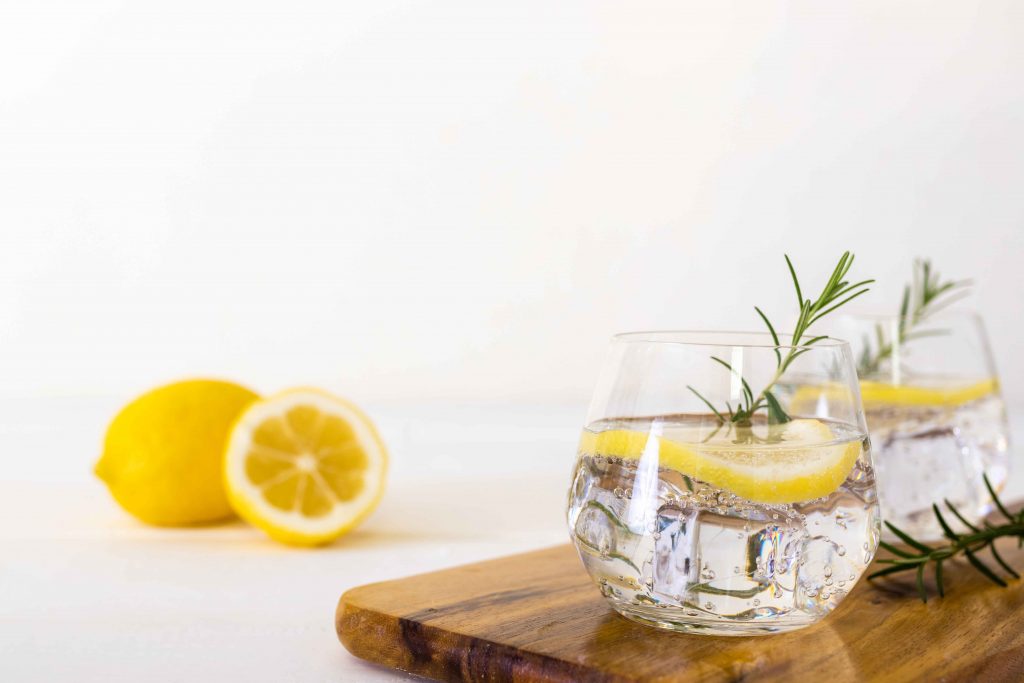 Flavored club soda Lemon drink on white wooden background. health drink concept.