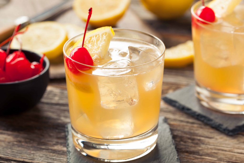Homemade Whiskey Sour Cocktail Drink with a Cherry Lemon